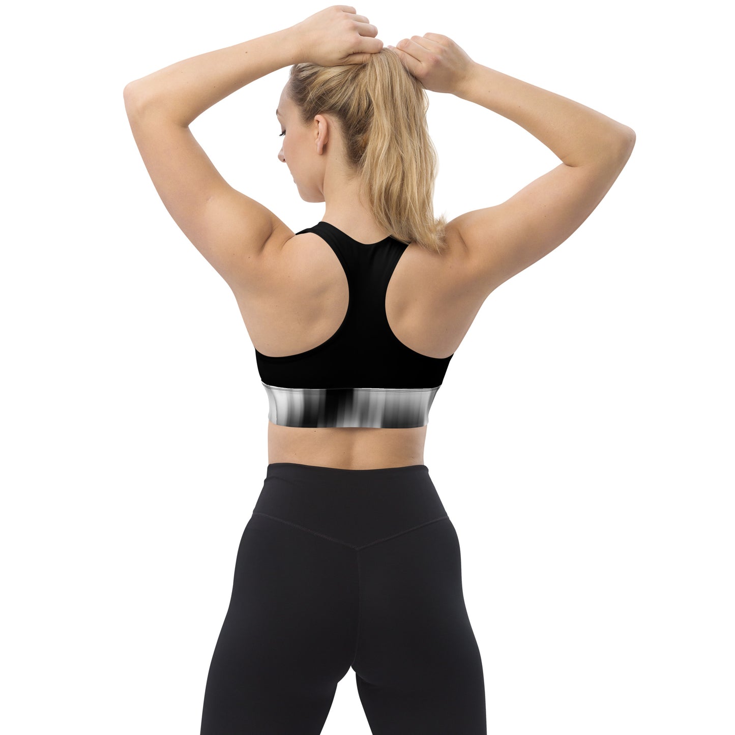 Back view of a woman wearing the Hellbeing recycled sports bra in black and grayscale