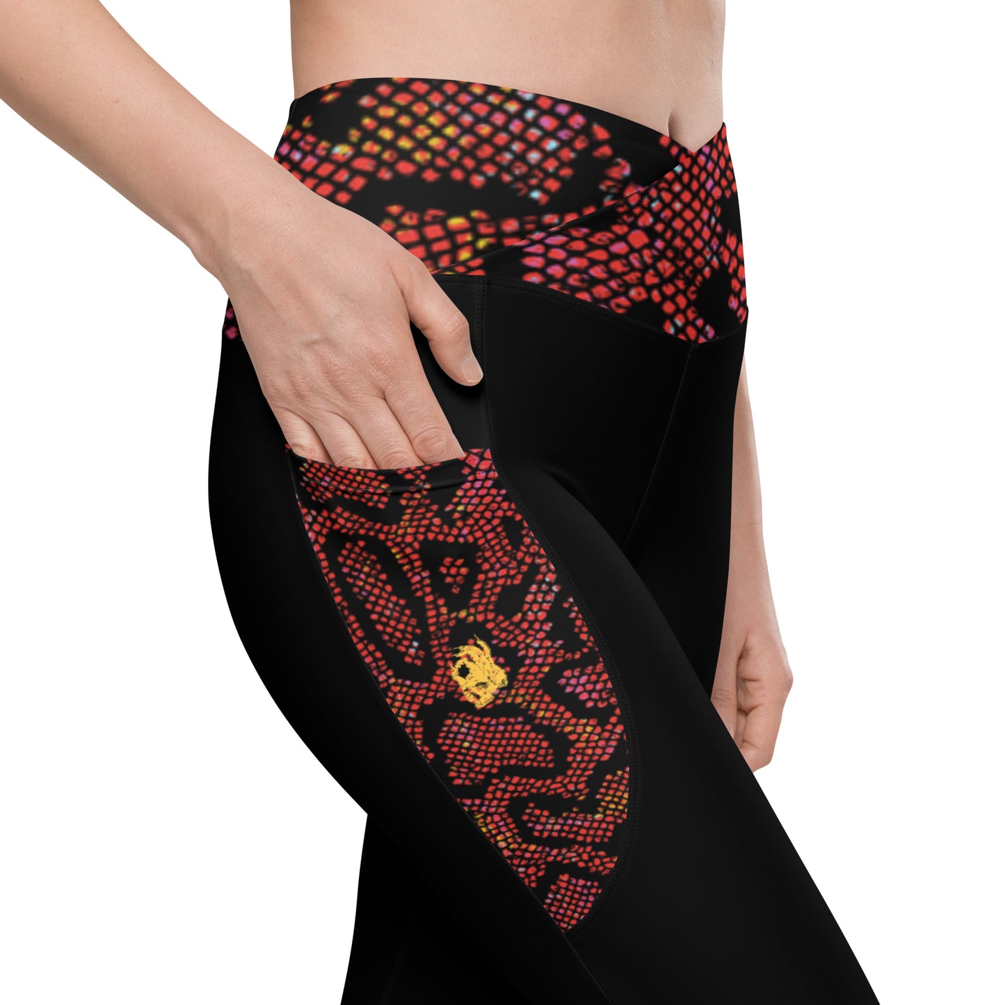 Right pocket view of the Hellbeing recycled crossover leggings in black and burgundy snakeskin