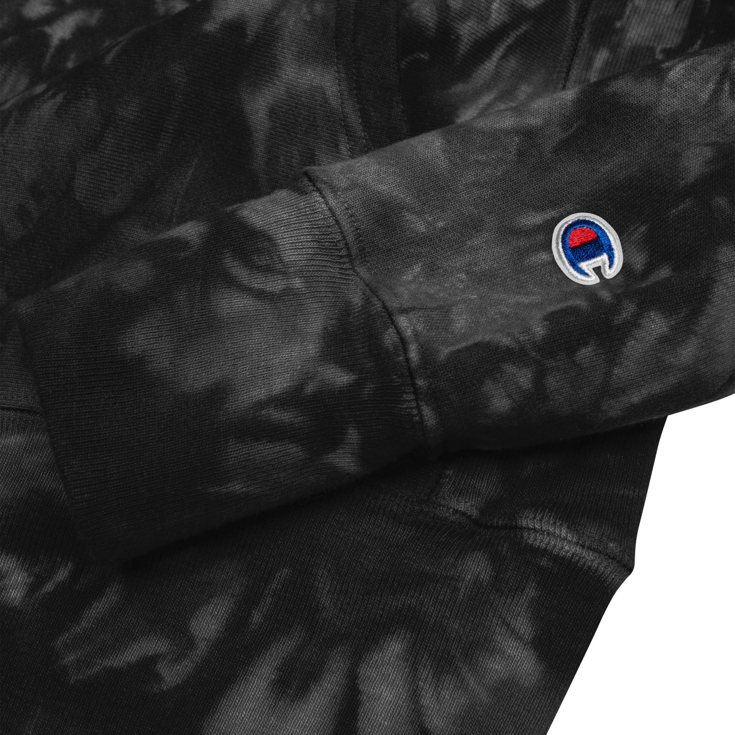 Zoomed in sleeve view of the Hellbeing skull embroidered premium Champion black tie dye hoodie