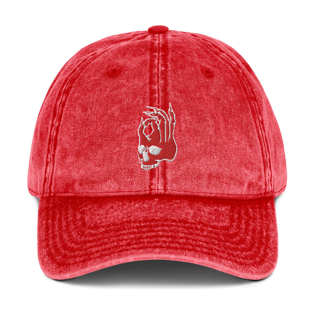 Front view of the Hellbeing skull embroidered vintage red cap