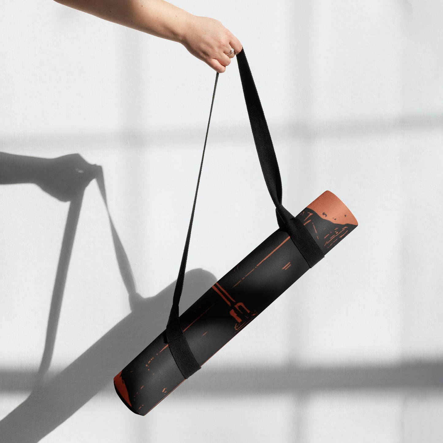 Rolled-up view of the Hellbeing black and red Lucifer, rubber Yoga mat with an anti-slip rubber bottom and microsuede top.