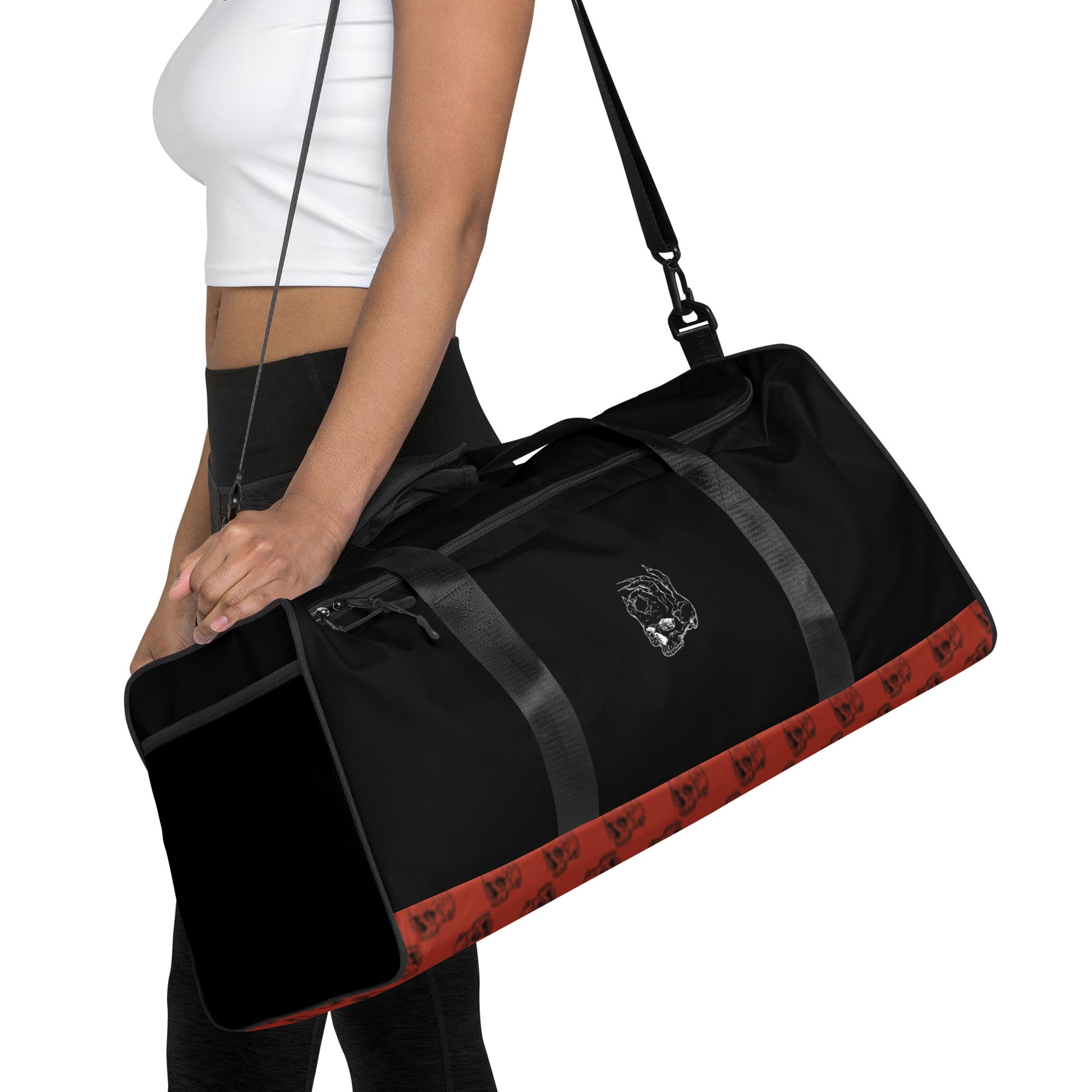 Hellbeing red and black skull logo pattern gym duffle bag on a woman's shoulder