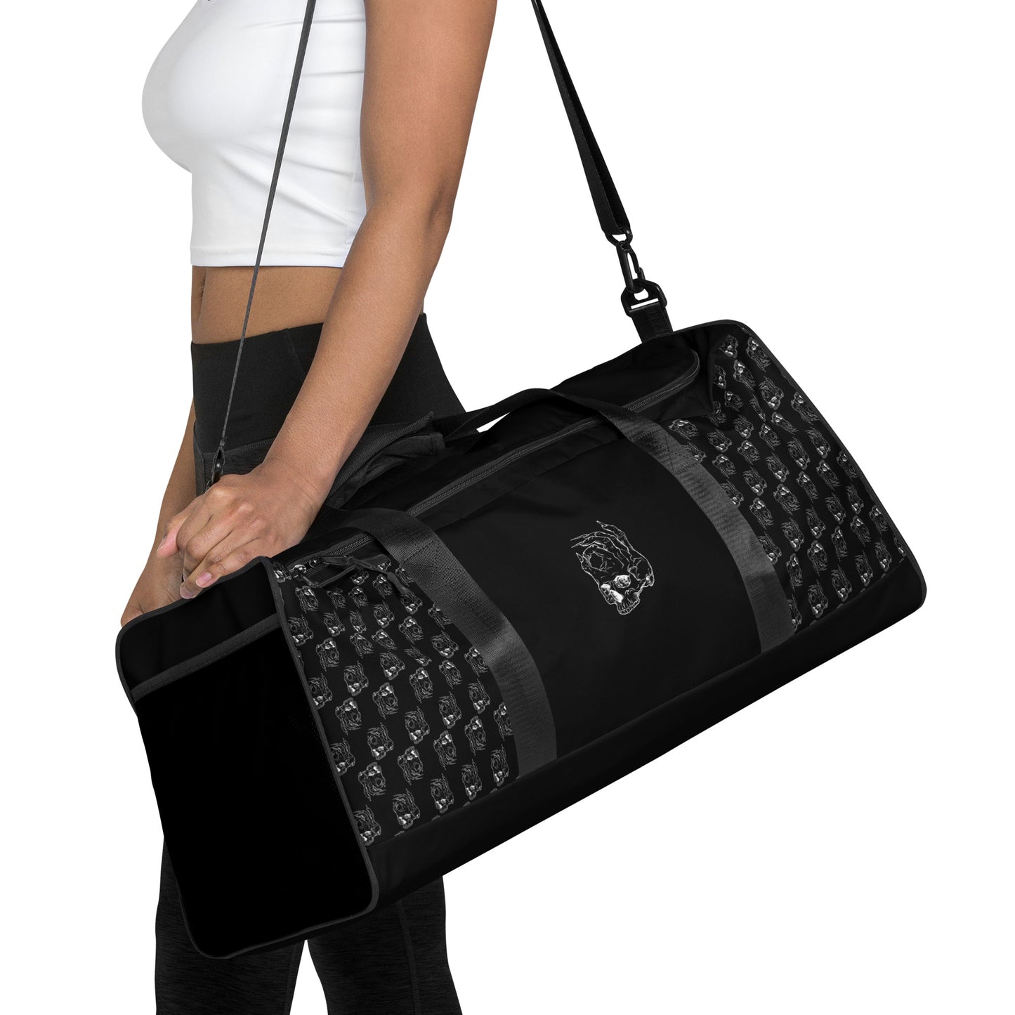 Hellbeing black and white skull logo pattern gym duffle bag on woman's shoulder