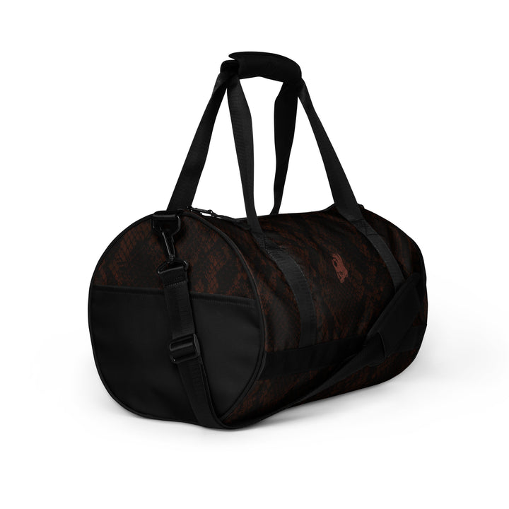 Hellbeing burgundy snakeskin print gym duffel bag with rust-red skull logo, right side view