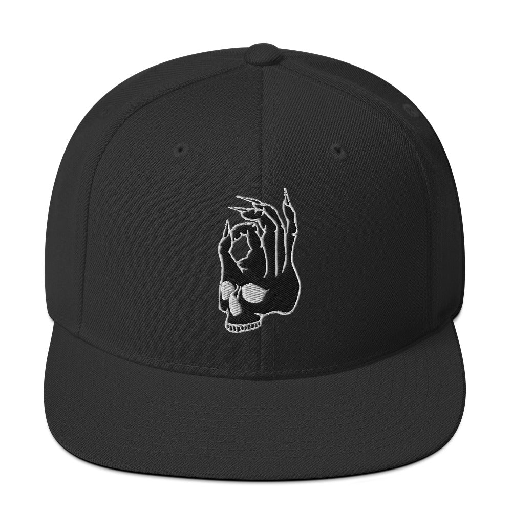 Front view of the Hellbeing skull embroidered classic black on black snapback hat