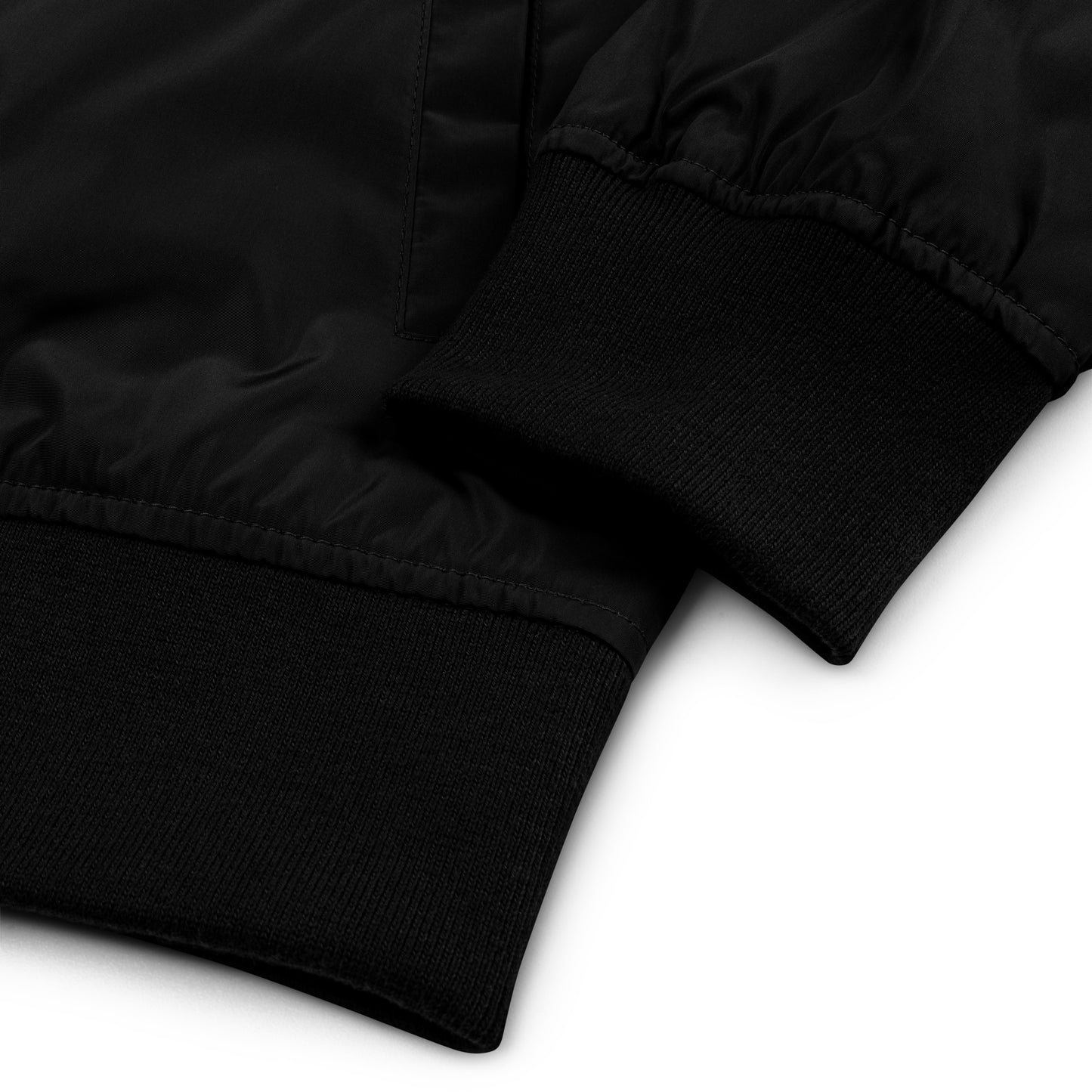 Zoomed in sleeve detail view of the Hellbeing premium recycled bomber jacket in black