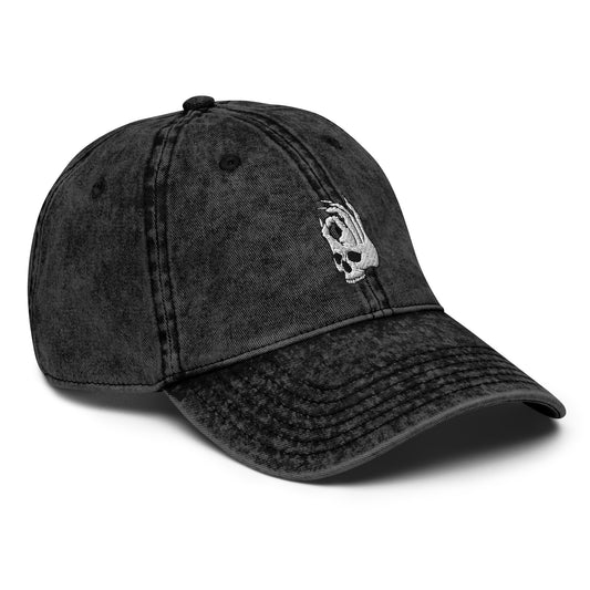 Front view of the Hellbeing skull embroidered vintage black cap