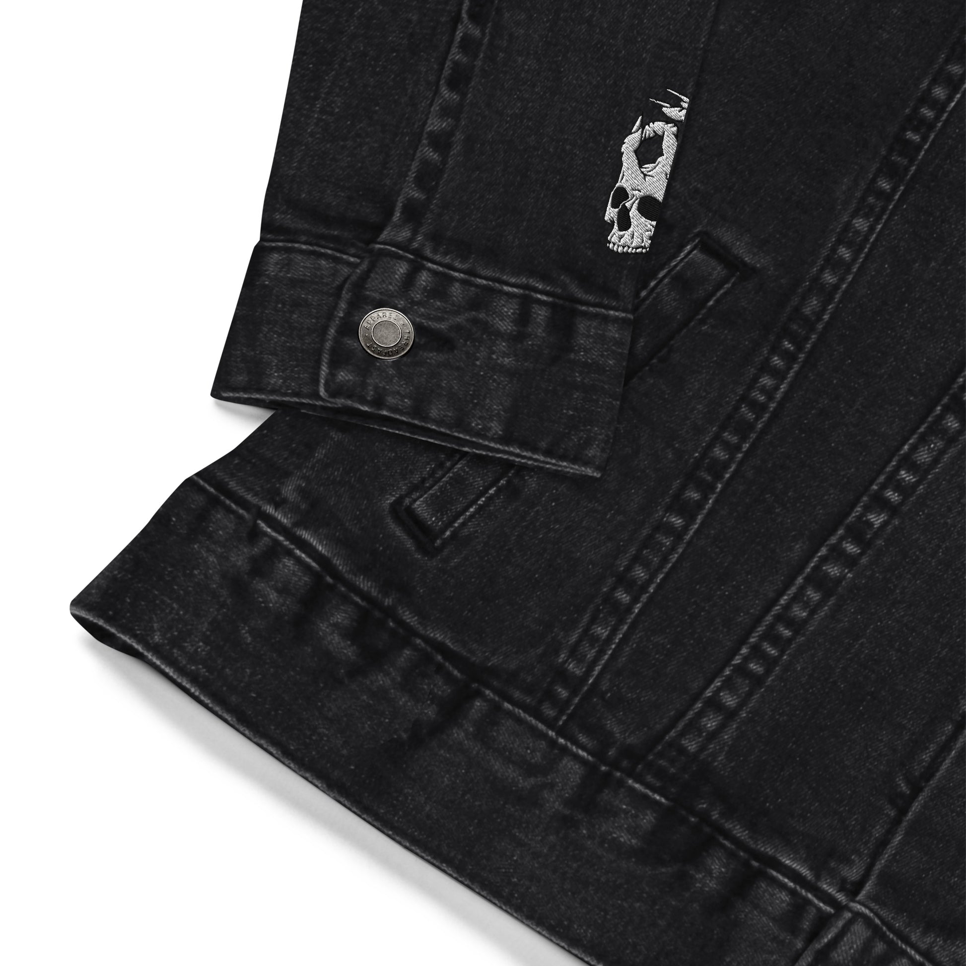 Zoomed in sleeve view of the Hellbeing skull embroidered black denim jacket