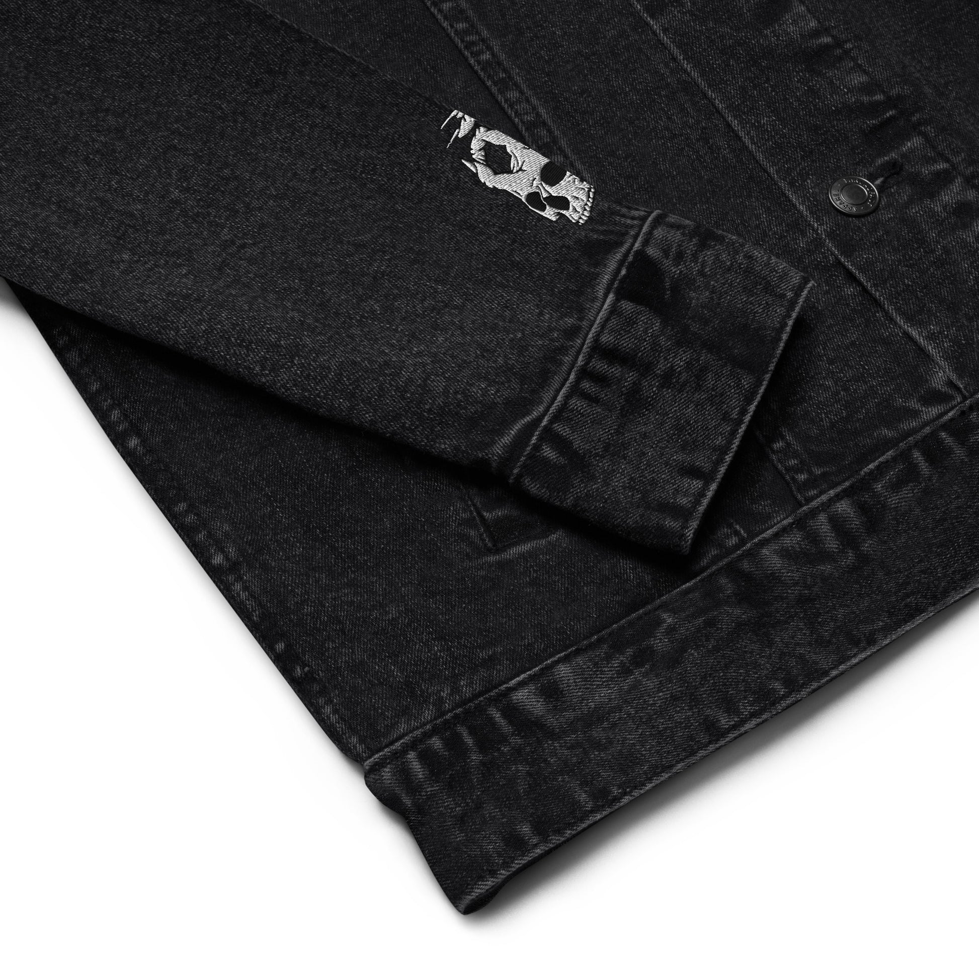 Zoomed in sleeve view of the Hellbeing skull embroidered black denim jacket