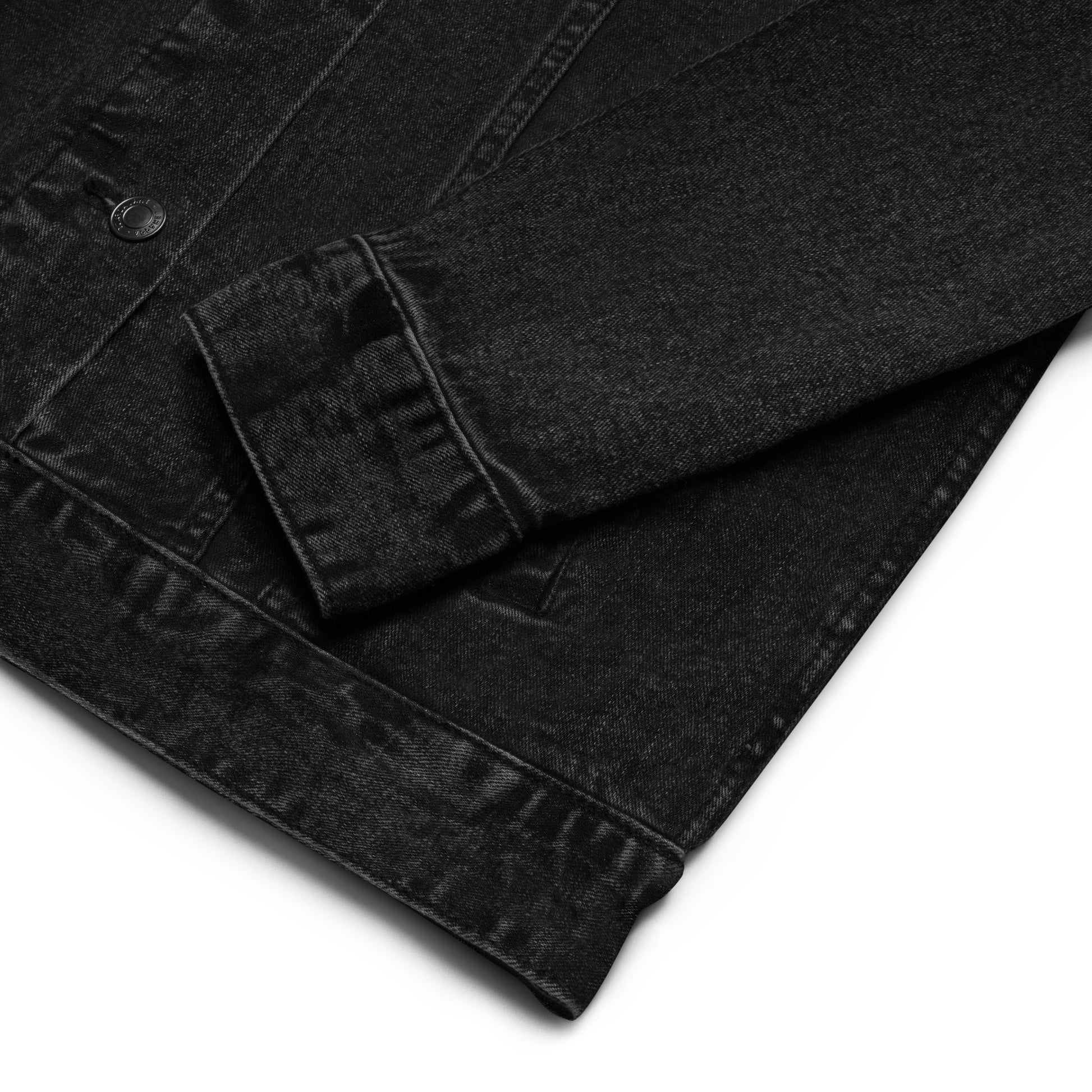 Zoomed in sleeve view of the Hellbeing skull embroidered black denim jacket