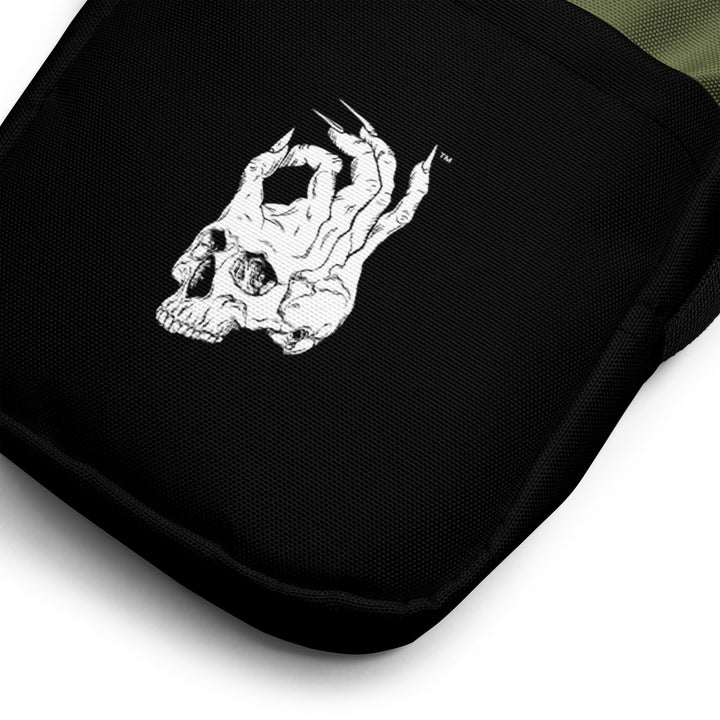 Hellbeing green and black utility crossbody bag, front pocket detail