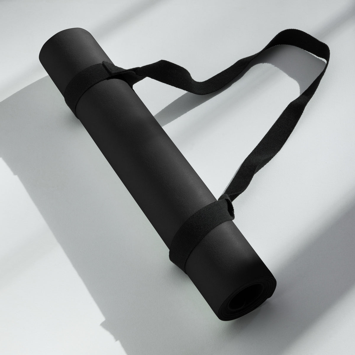 Hellbeing solid black yoga and exercise mat with gray skull logo in the corner, product photo 6 of 7