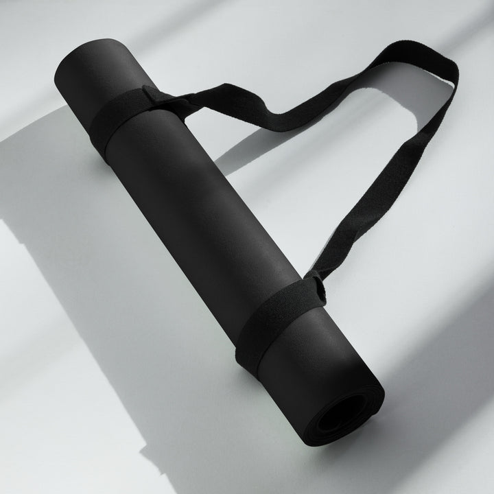 Hellbeing solid black yoga and exercise mat with gray skull logo in the corner, product photo 6 of 7