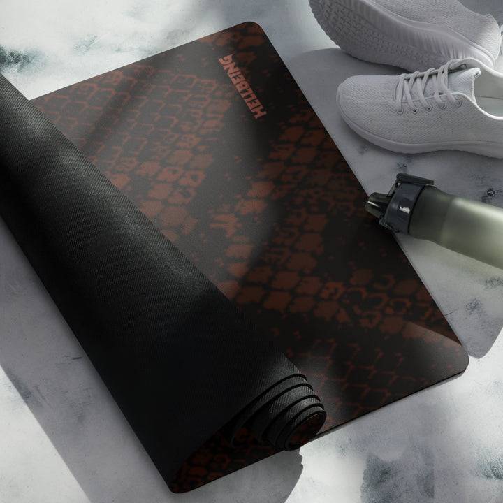 Hellbeing burgundy snakeskin print yoga and exercise mat with rust-red skull logo in the corner, product photo 4 of 6